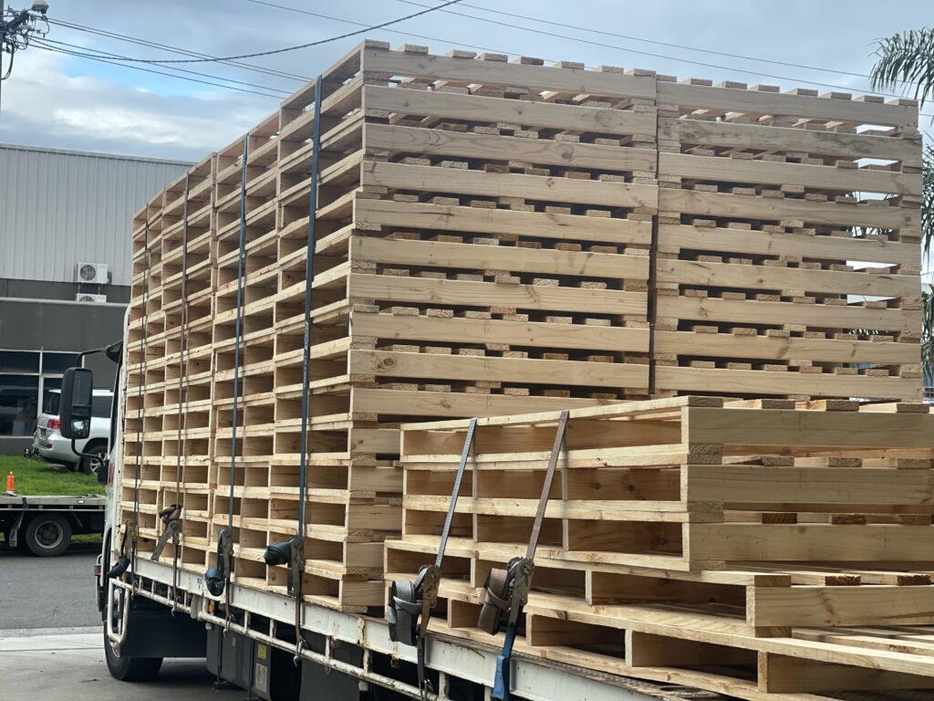 wooden pallets stacked on back of truck outside Crate n Pack Solutions warehouse