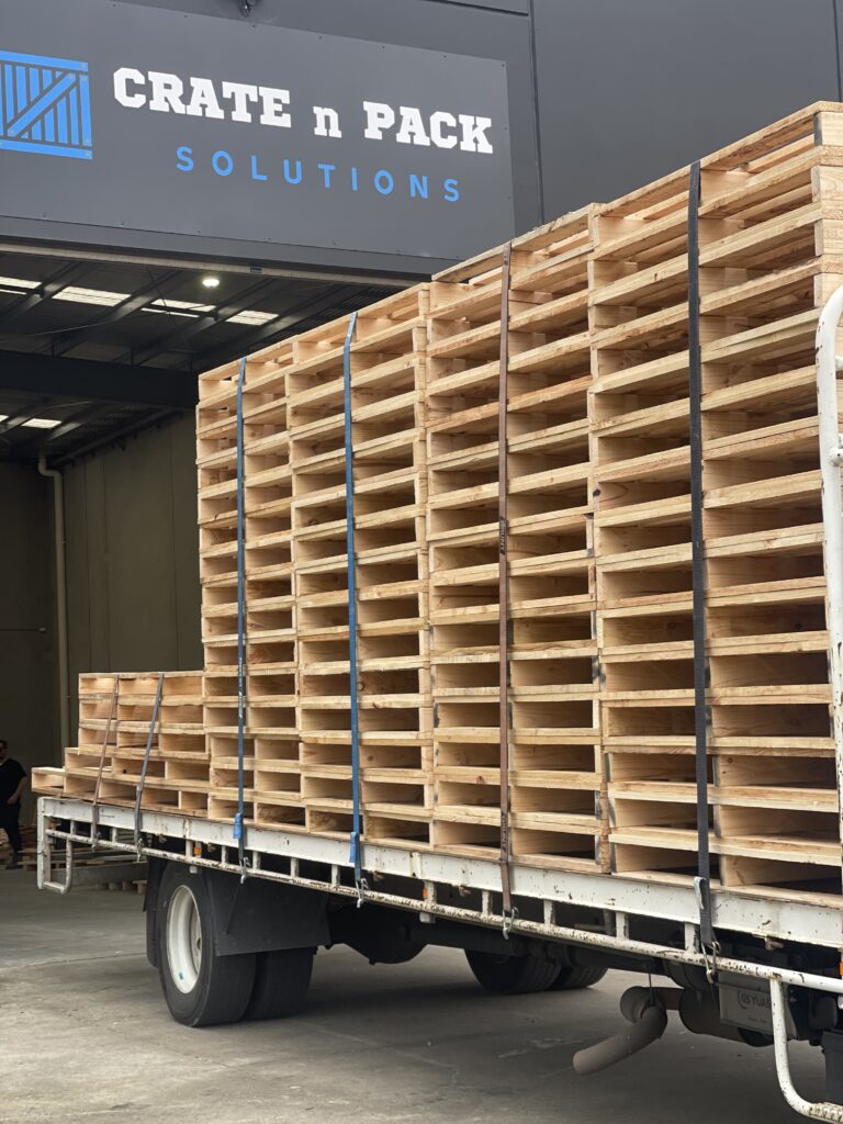 wooden pallets stacked on back of truck outside Crate n Pack Solutions warehouse