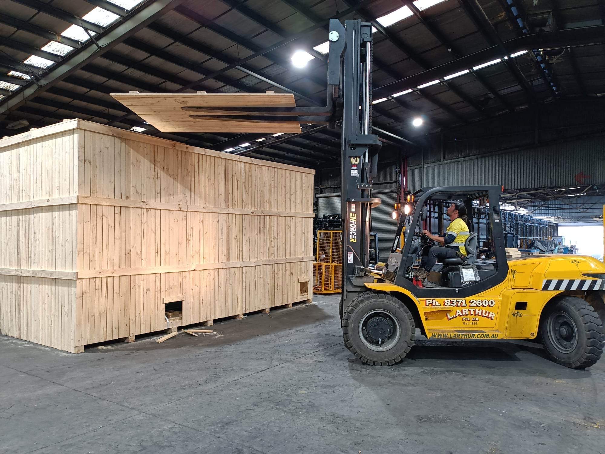 large wooden shipping crate and forklift